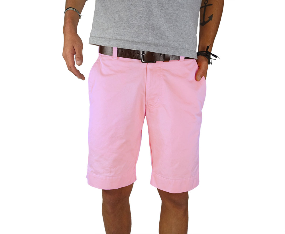 Man standing wearing pink twill shorts - Front view
