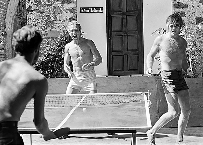 Black & White Photo of Paul Newman & Robert Redford Playing Ping Pong & wearing shorts